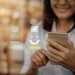 Image of a lady smiling and holding her phone. Picture is being used for a blog post about customer engagement.