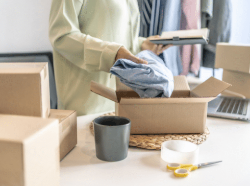 Image of a lady packing a piece of clothing into a shipping box. Image is being used for a product launch press release blog.