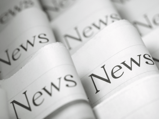 Picture of folded newspapers with the word "News" written on each headline. Image is being used for a Newswire blog titled, "Press Release Headlines Don't Have to be Boring."