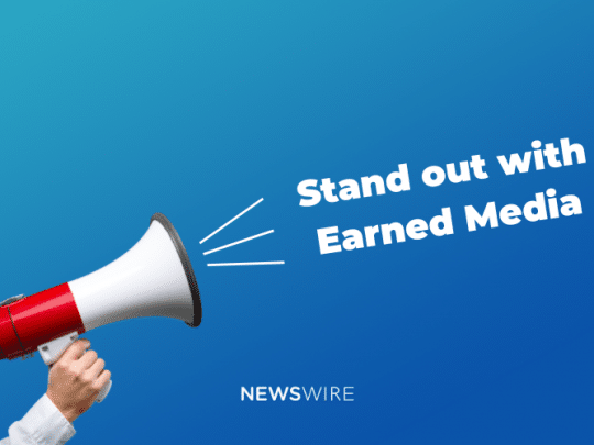 Picture of a red and white megaphone with a blue background. Text reads, Stand out with Earned Media.