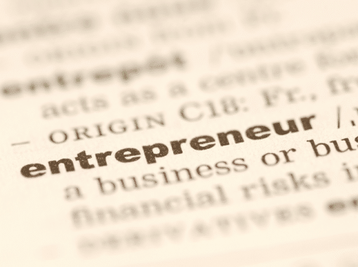 Picture of a dictionary with the word "entrepreneur" in bold font. Image is used for a Newswire blog about marketing tips for entrepreneurs.