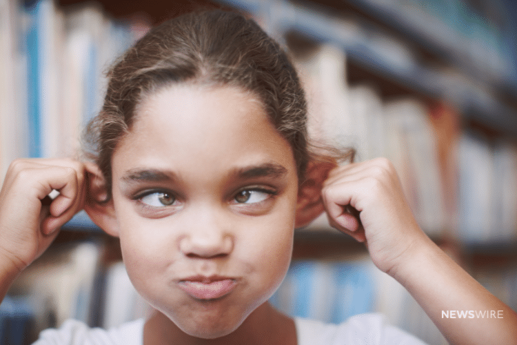 Newswire branded image of a little girl making a silly face in a school. Image is being used for a blog post about reputation management.