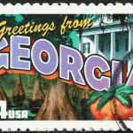 Picture of a "Greetings from Georgia" stamp. Image is being used for a Newswire blog post about the top media outlets in Georgia.