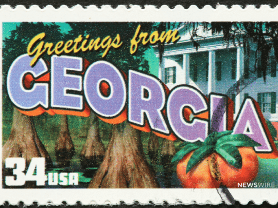 Picture of a "Greetings from Georgia" stamp. Image is being used for a Newswire blog post about the top media outlets in Georgia.