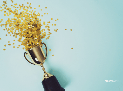 Picture of a trophy with gold confetti coming out of it on a blue background. Newswire branded image.