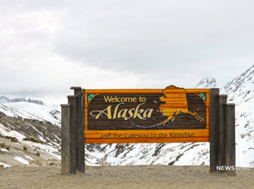 Picture of "Welcome to Alaska" sign with snow and gray clouds in the background. Image is used for a Newswire blog post about the top media outlets in Alaska.